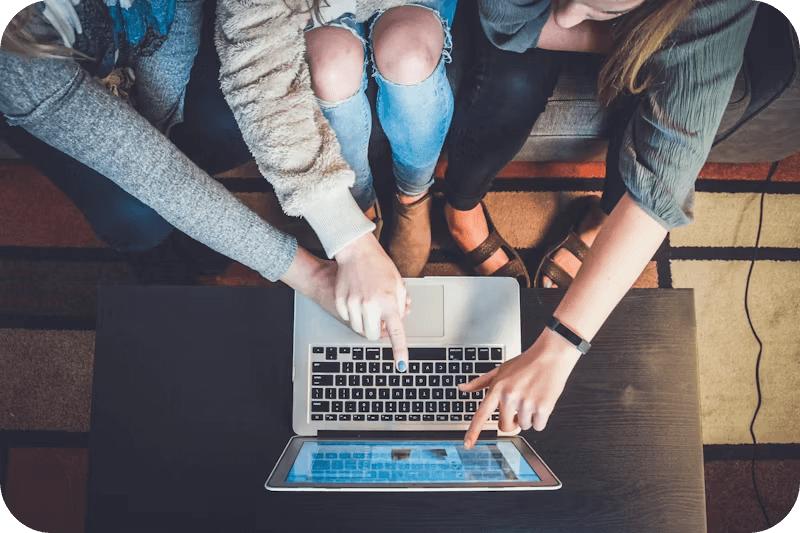 three-person-pointing-the-silver-laptop-computer