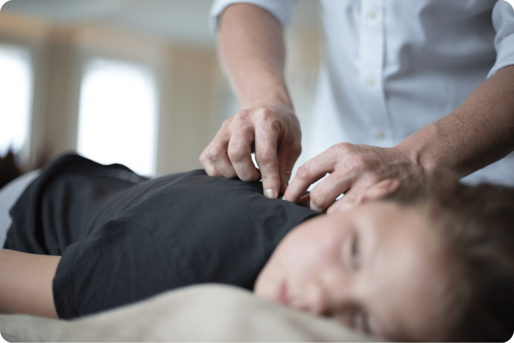 a-woman-getting-a-massage-from-a-man-in-a-white-shirt